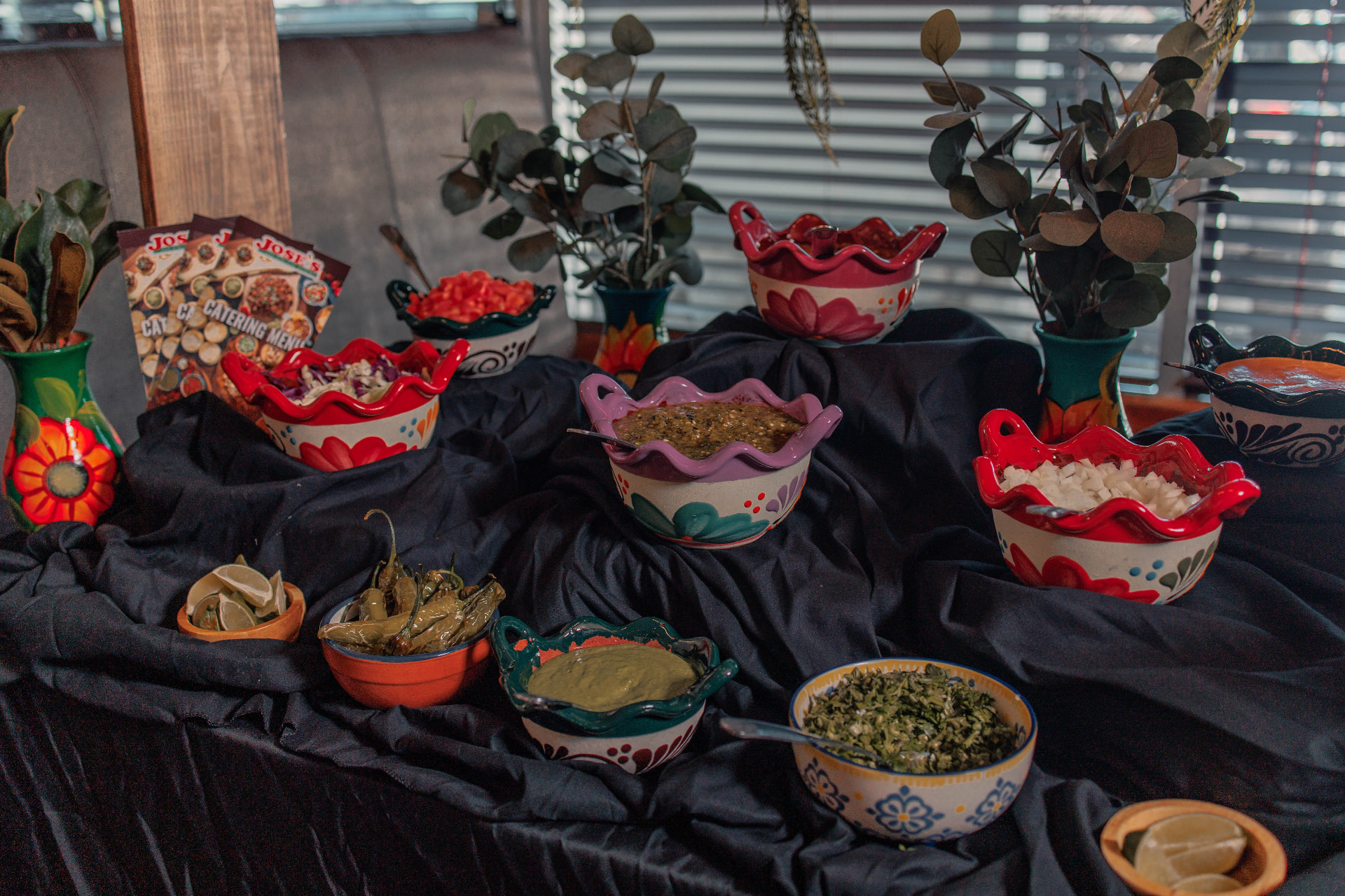 Salsas, cilantro, onions and fixings on the José's taco bar