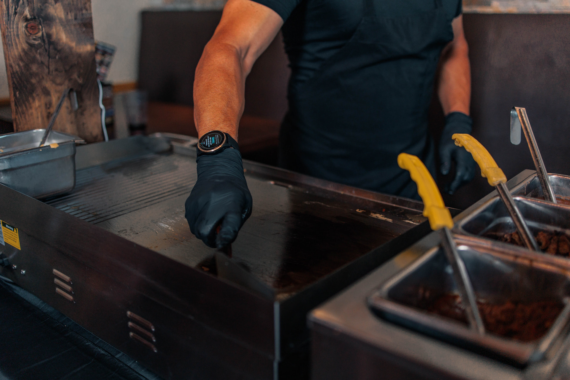 Cook working the flat top at the José's taco stand